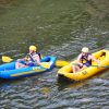 People in inflatable kayaks in river