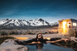 man relaxing in hot springs pool